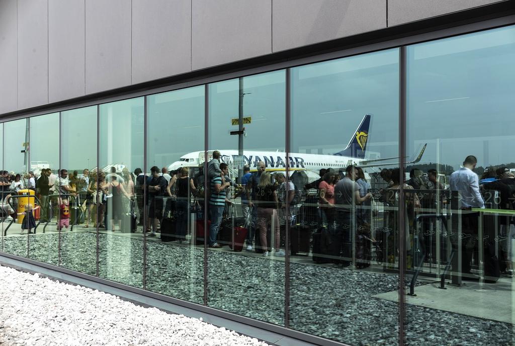 Traveler reaching out for communication at airport lounge